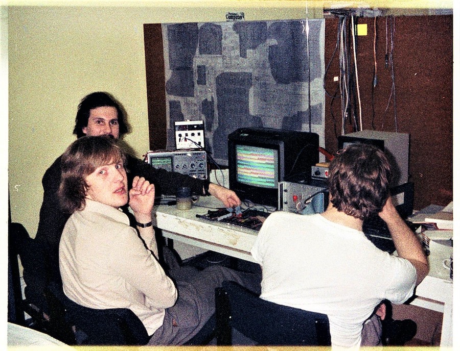 Steve Furber linkedin.com/in/stevefurber (bottom left) in 1981 (with Alan Wright behind) debugging wire-wrapped prototypes of the BBC Micro. Picture re-used with kind permission from Chris Turner (Turner 2020)