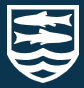 The badge of St. Laurence School. The emblem is an adaptation of the Fitzmaurice badge with a pair of gudgeon fish symbolising the union of the two schools St. Laurence was created from: Trinity secondary modern school and Fitzmaurice Grammar School.