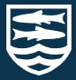 The badge of St. Laurence School. The emblem is an adaptation of the Fitzmaurice badge with a pair of gudgeon fish symbolising the union of the two schools St. Laurence was created from: Trinity secondary modern school and Fitzmaurice Grammar School.